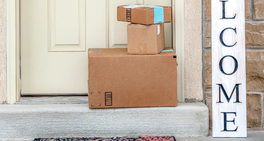 Boxes by the door of a residence with a welcome sign in Green Bay